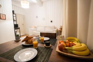 a table with a plate of fruit and orange juice at Charming Elegant Suite - Downtown - AF in Carcassonne +9 photos
