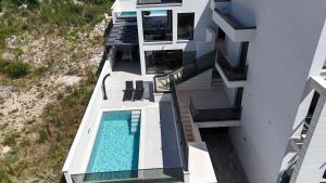 an aerial view of a house with a swimming pool at Luxurious Sea-View 2BR Apartment with Private Pool-Villa Quadris-Crikvenica in Crikvenica