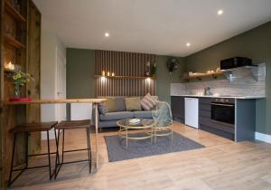 a kitchen and living room with a couch and a table at City to Country Retreat Luxury Lodges with Hot Tub, BBQ, Fire Pit in Toppesfield