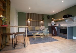 a woman standing in the kitchen of a living room at City to Country Retreat Luxury Lodges with Hot Tub, BBQ, Fire Pit in Toppesfield +45 photos