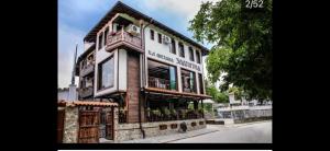 a large wooden building on the side of a street at Златоград in Zlatograd