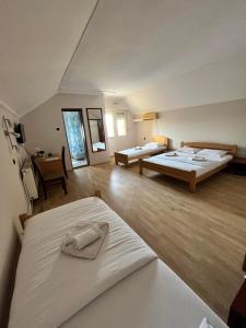 a large room with two beds and a table at Guest house Vila Bor in Novi Sad