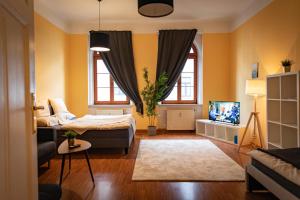 a bedroom with a bed and a couch and a tv at FullHouse - Görlitz - B7 - 3 Bedrooms - SmartTV - Nespresso in Görlitz