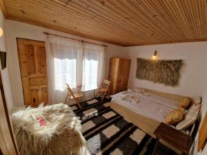 a bedroom with a large bed and a window at The House in Stoykite