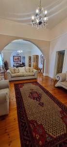 a living room with two couches and a rug at 14th on West in Graaff-Reinet