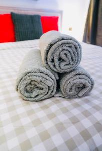 a pile of towels sitting on top of a bed at Les princesses studio confort-plus charme in Maarif +31 photos
