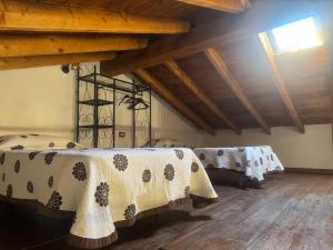 a room with two beds in a room with wooden floors at Casa granero 2 in El Río +16 photos