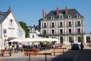 a group of people sitting at tables in front of a building at Blois La Tour 1696 in Blois