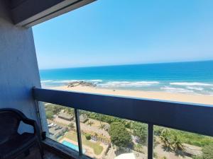 a balcony with a view of the beach and the ocean at Stella Maris 135 in Amanzimtoti