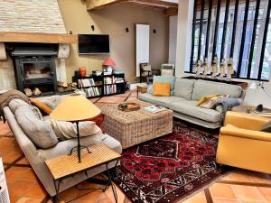 a living room with couches and a fireplace at Domaine des Monges in Saint-Seurin-de-Prats