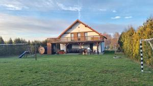 a large house with a playground in the yard at Dom letniskowy Sieraków in Sieraków
