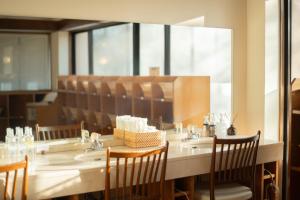 ein Restaurant mit einem Tisch, Stühlen und einem großen Spiegel in der Unterkunft Hotel Goryukan in Hakuba + 19 Fotos