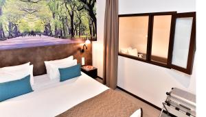 Cama ou camas em um quarto em Central Park Hôtel & Spa