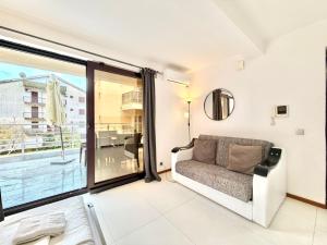 a living room with a couch and a large window at Apartments Villa Stefan in Budva