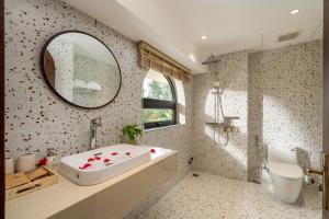 a bathroom with a tub and a sink and a mirror at SEAESTA An Bang in An Bàn (2) +30 photos