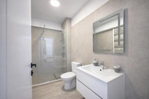 a bathroom with a toilet and a sink and a shower at Waves 342 Infinity in Mamaia Sat/Năvodari