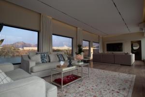 a living room with a couch and a table at SS Resorts - Private Luxury Villa in Hatta