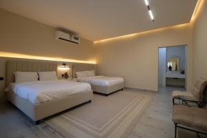 a hotel room with two beds and a couch at SS Resorts - Private Luxury Villa in Hatta