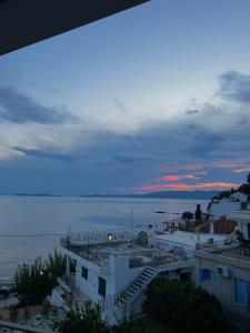 a view of the ocean at sunset from a building at SEA HOME Accommodation in Loutraki