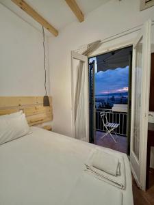 a bedroom with a bed and a view of a balcony at SEA HOME Accommodation in Loutraki