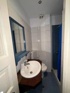 a small bathroom with a sink and a toilet at SEA HOME Accommodation in Loutraki