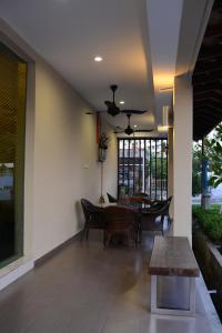 a living room with a table and a dining room at Marina Oriental Hotel in Butterworth