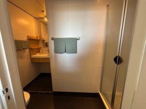 a bathroom with a shower and a toilet at Bed&Breakfast aan Strand in Katwijk aan Zee +70 photos