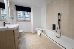 a bathroom with a tub and a toilet and a sink at La Pigna Boutique Apartment in Rome +25 photos