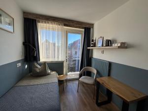 a small room with a table and a window at Bed&Breakfast aan Strand in Katwijk aan Zee