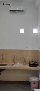 a kitchen with a sink and a counter top at MEWAH guest house in Karangploso