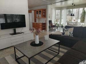 a living room with a couch and a tv at Björktorpet och Soltorpet in Lepplax