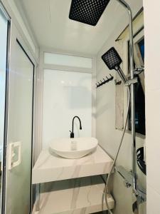 a bathroom with a sink and a shower at Silk Homestay LVC Central in Hanoi