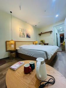 a hotel room with a bed and a table with a table at Silk Homestay LVC Central in Hanoi