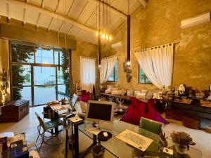 a living room with a couch and a desk with a computer at Lucca In Villa Elisa & Gentucca in Lucca