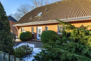 a brick house with snow in front of it at Appartement Dorfluft in Böhl