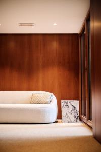 two beds in a room with wooden walls at Romantik Hotel le Val d'Amblève in Stavelot