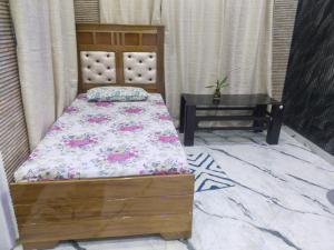 a small bedroom with a bed and a table at Sukoon Villa in Tezpur