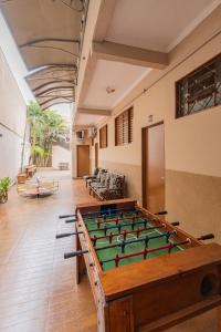 a pool table in the middle of a room at Hotel Portela II - Av Principal e a 500m do Thermas dos Laranjais in Olímpia
