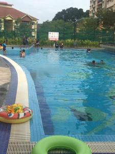 a swimming pool with a dolphin in the water at Casa Melaka in Kampong Pulau Sebang