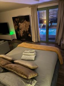 a room with a bed with two towels on it at SuitePoolBarcelona in Vilassar de Dalt
