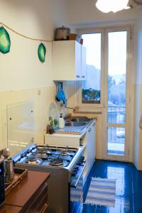 a kitchen with a stove top oven next to a window at Monstera room Vicino al centro in Perugia +50 photos