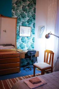 a bedroom with a desk and a chair and a mirror at Monstera room Vicino al centro in Perugia