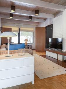 a living room with a couch and a television at Villa Pulla - House Near Nature & City Center in Rovaniemi