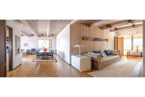 a living room with a couch and a table at Villa Pulla - House Near Nature & City Center in Rovaniemi