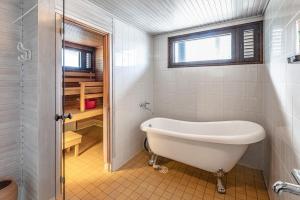 a bath tub in a bathroom with a window at Villa Pulla - House Near Nature & City Center in Rovaniemi +40 photos