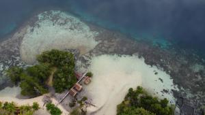an aerial view of an island in the ocean at War Homestay in Pulau Minyaifuin