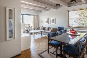 a dining room and living room with a table and chairs at Villa Pulla - House Near Nature & City Center in Rovaniemi
