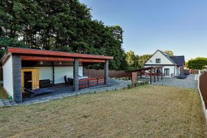 a house with a pavilion next to a yard at Silver Cottage in Máriapócs