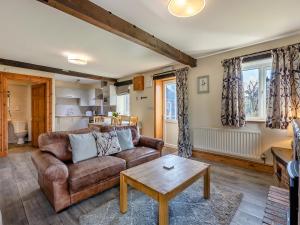 a living room with a couch and a table at Milking Parlour - Uk48911 in Allonby