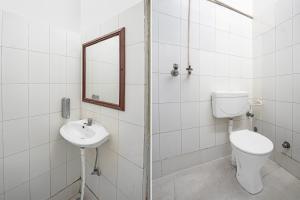a bathroom with a toilet and a sink and a mirror at Hotel O ANANT ONE HOTEL AND BANQUETS in Ghaziabad